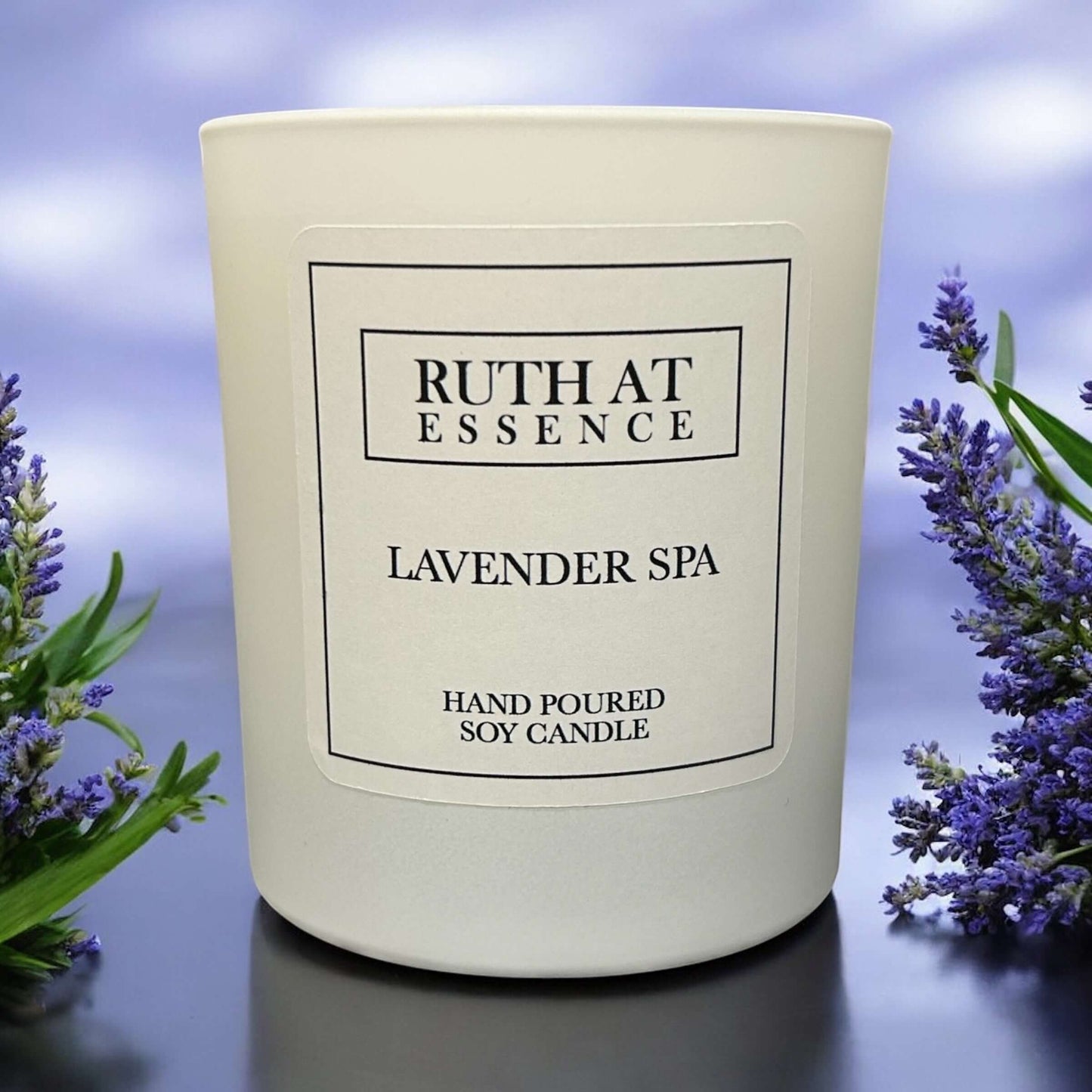 Handmade lavender spa candle in a white vessel, made from 100% soy wax, vegan friendly, promoting relaxation.