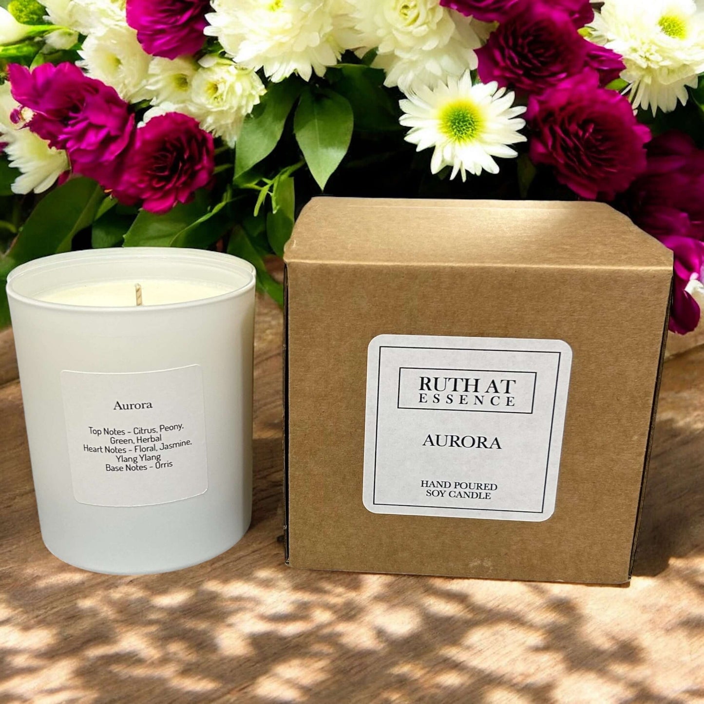 Handmade Aurora candle in a glass jar with floral packaging, vegan friendly and made from 100% soy wax.