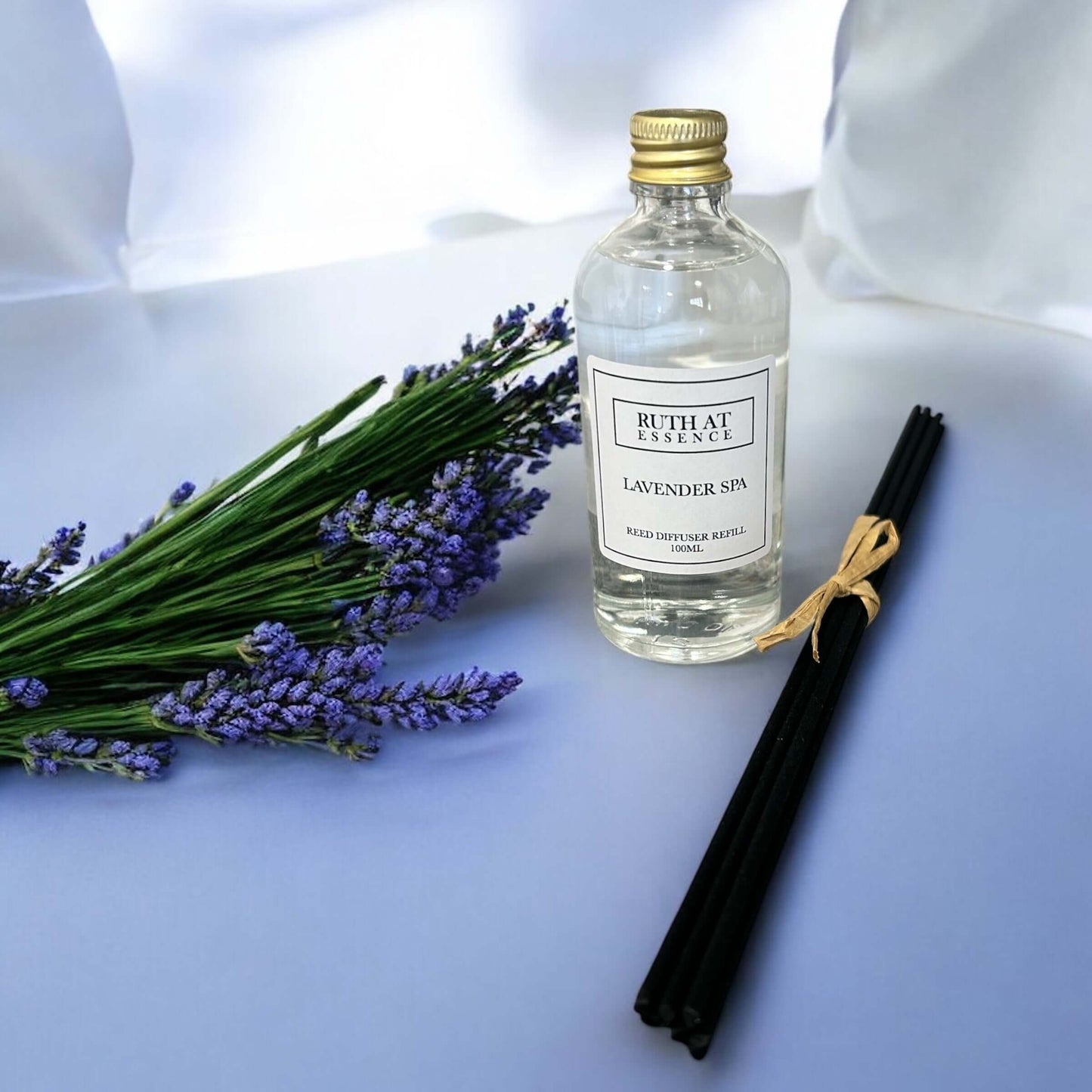 Lavender spa diffuser refill 100ml with black reeds and lavender flowers creating a relaxing atmosphere.