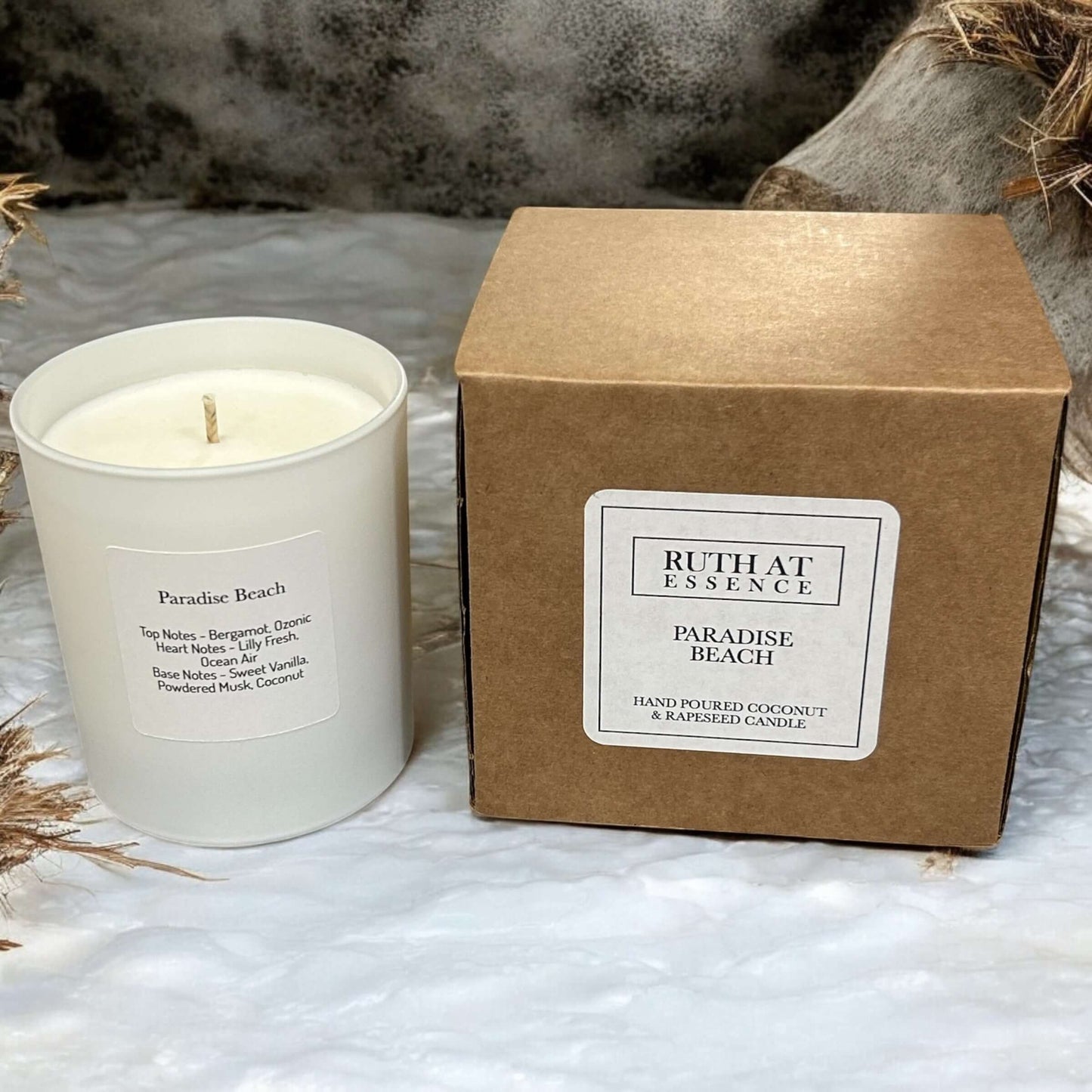 Handmade Paradise Beach candle in white jar with kraft box, featuring coconut and vanilla scent, vegan friendly.