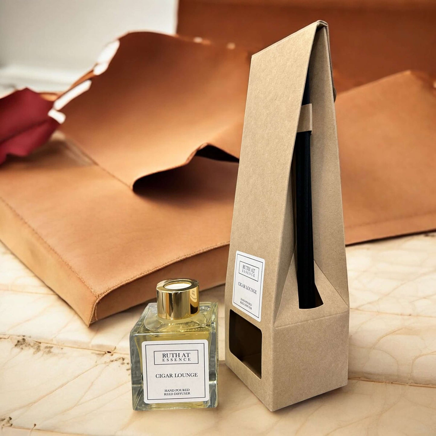 Handmade Cigar Lounge reed diffuser in elegant packaging, surrounded by leather, vegan-friendly fragrance experience.