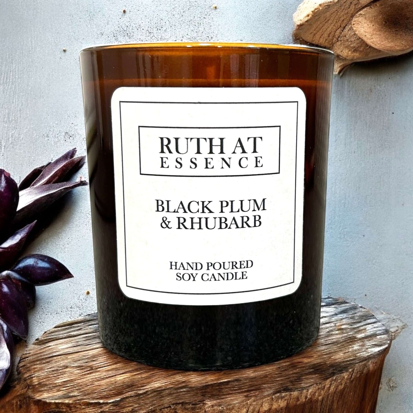 Handmade soy candle in amber jar featuring Black Plum & Rhubarb scent, vegan friendly, perfect for year-round freshness.