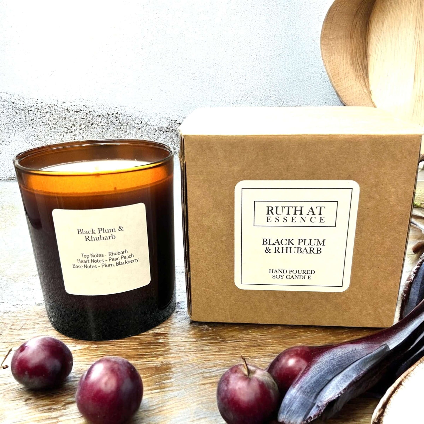 Handmade Black Plum & Rhubarb candle in a jar with packaging, vegan friendly, aromatic scent for home.