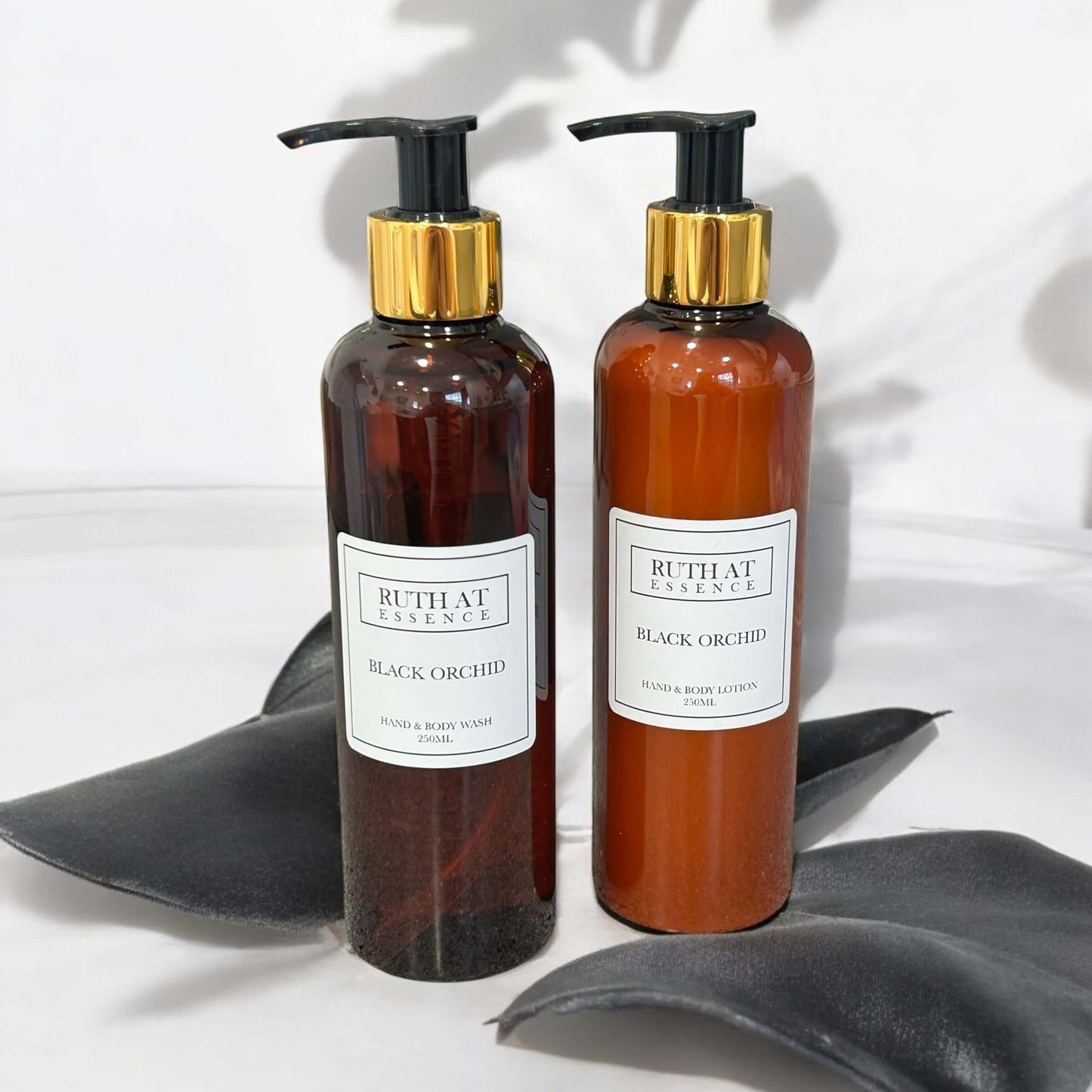 Black Orchid hand & body lotion bottles; luxurious, vegan-friendly skincare product.