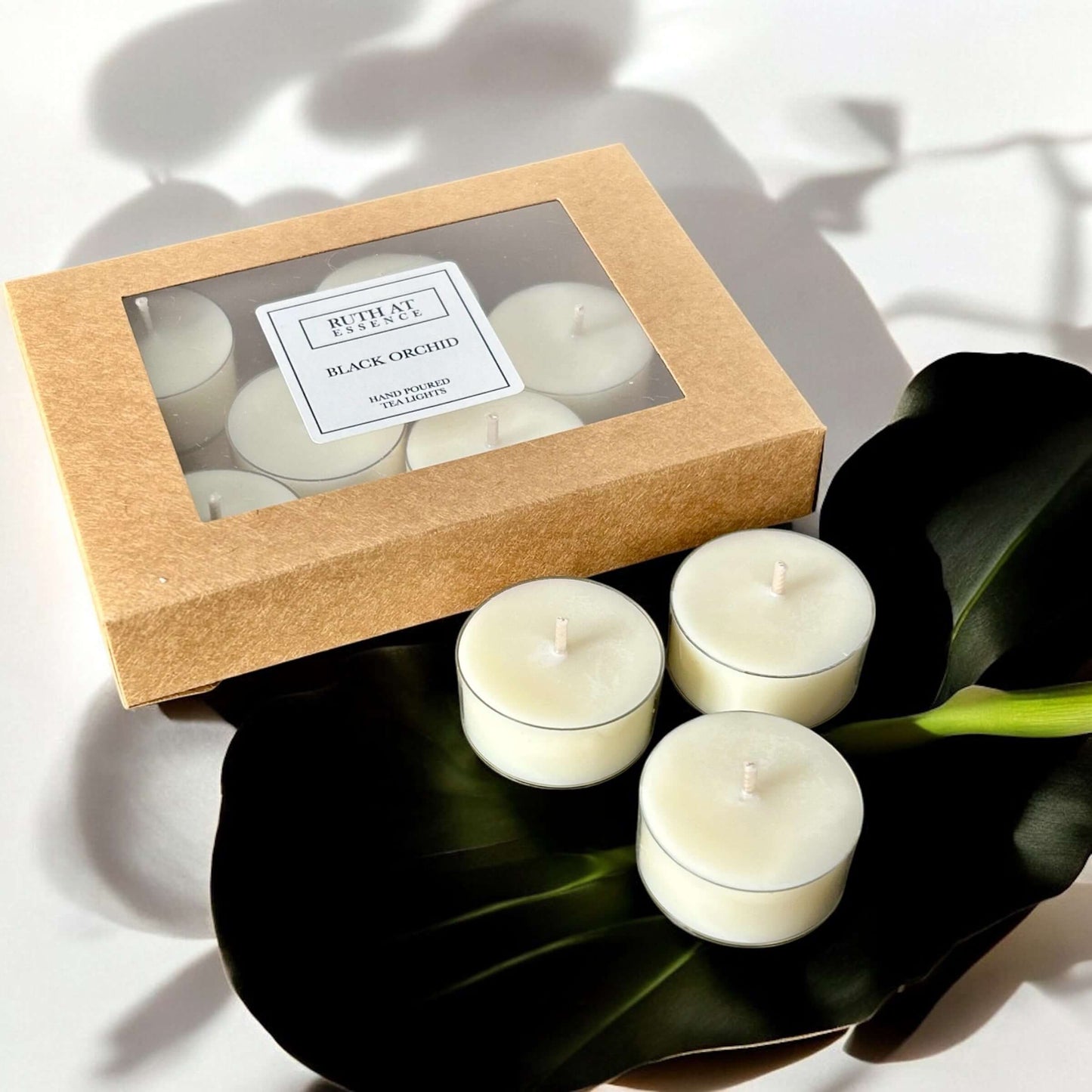 Handmade Black Orchid tea lights box with 9 vegan friendly candles, offering luxurious scent and ambiance.