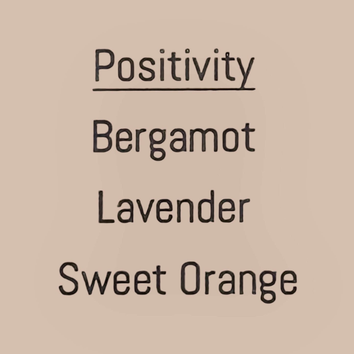 Text list of essential oils: Positivity, Bergamot, Lavender, and Sweet Orange for a mood-boosting candle.