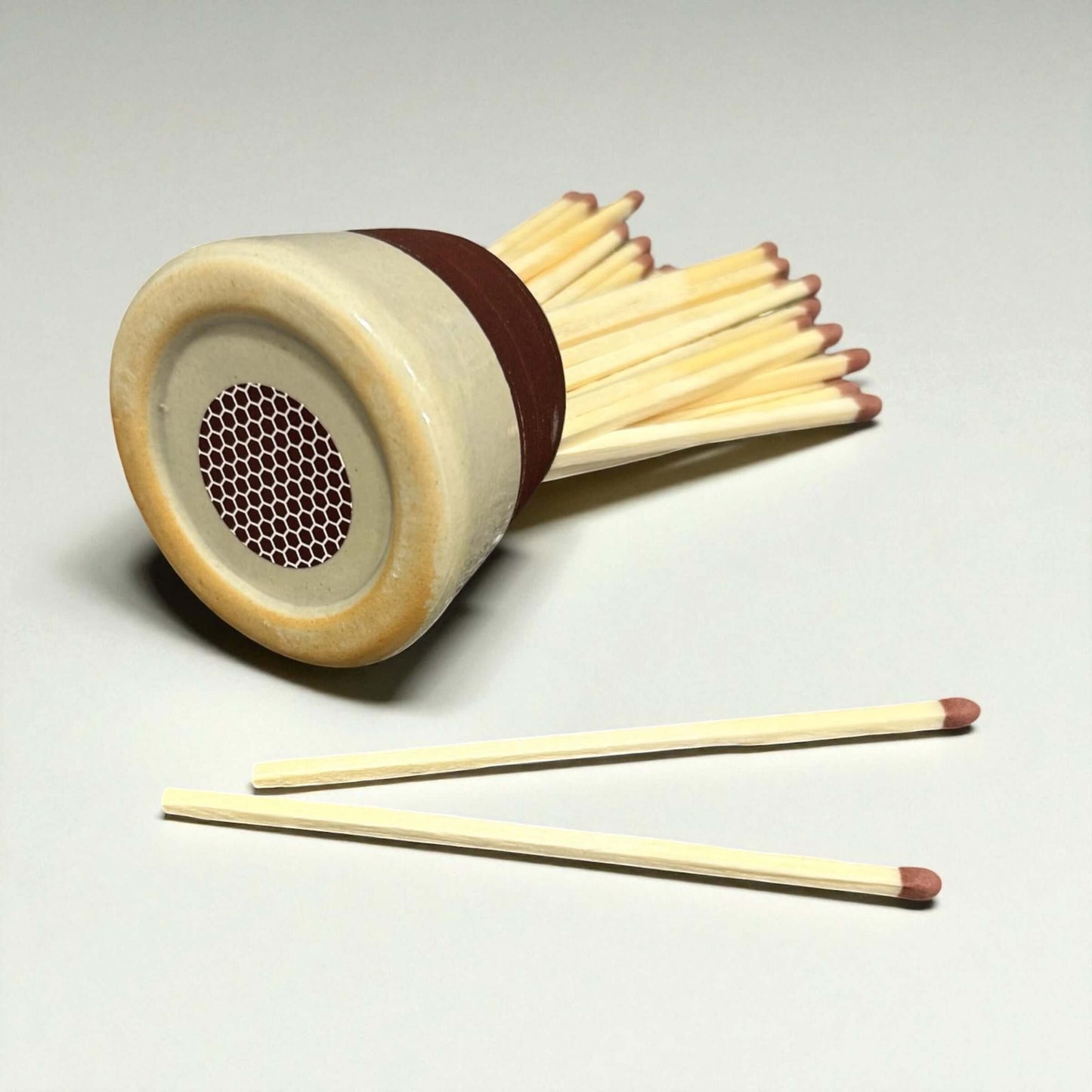 Ceramic Matchstick Holder - Milk with matches spilling out on a light background.