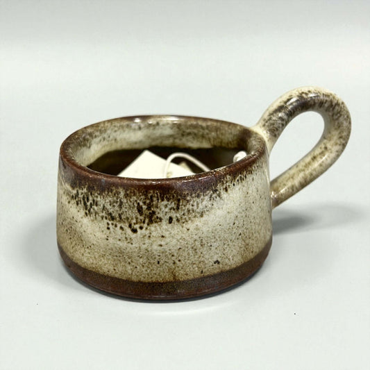 Stoneware Tawny Tea-Light Holder in warm tawny reactive glaze with charming handle.