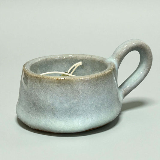 Stylish Stoneware Eggshell Tea-Light Holder designed for a warm glow, featuring a soft eggshell glaze and sweet handle.